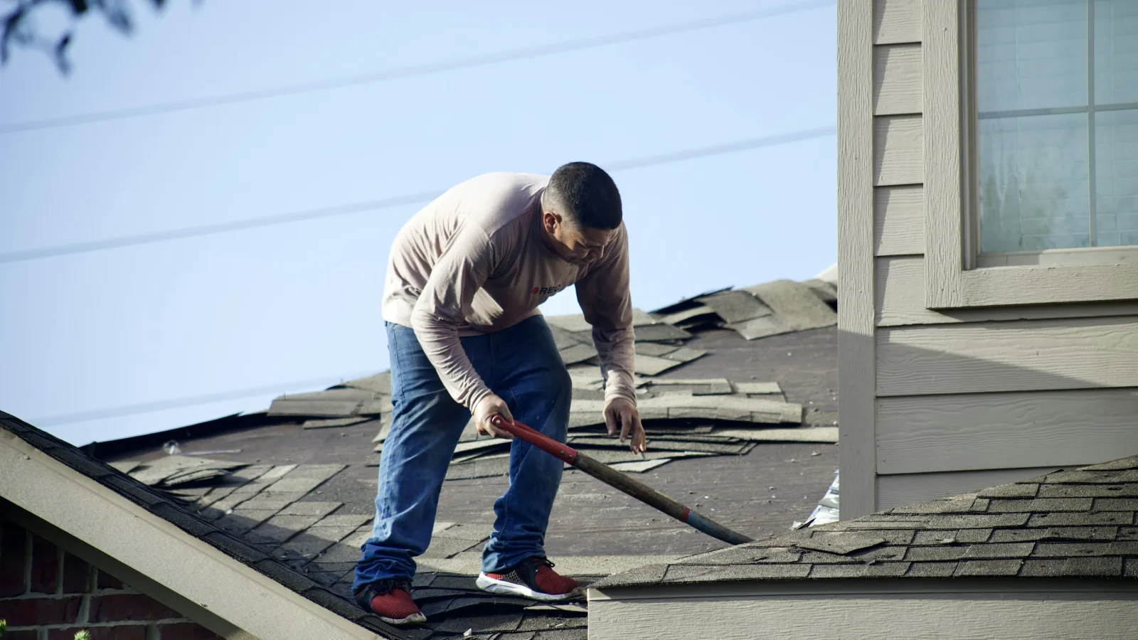 a man cleaning a roof