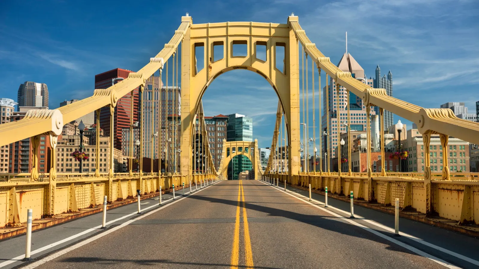 a bridge with a road and buildings on the side