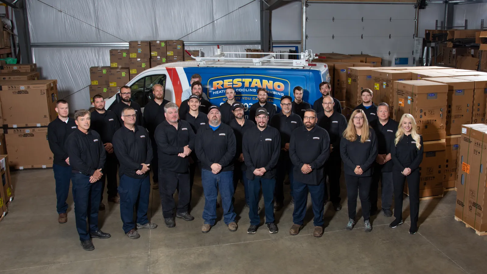 a group of people posing for a photo in front of a truck