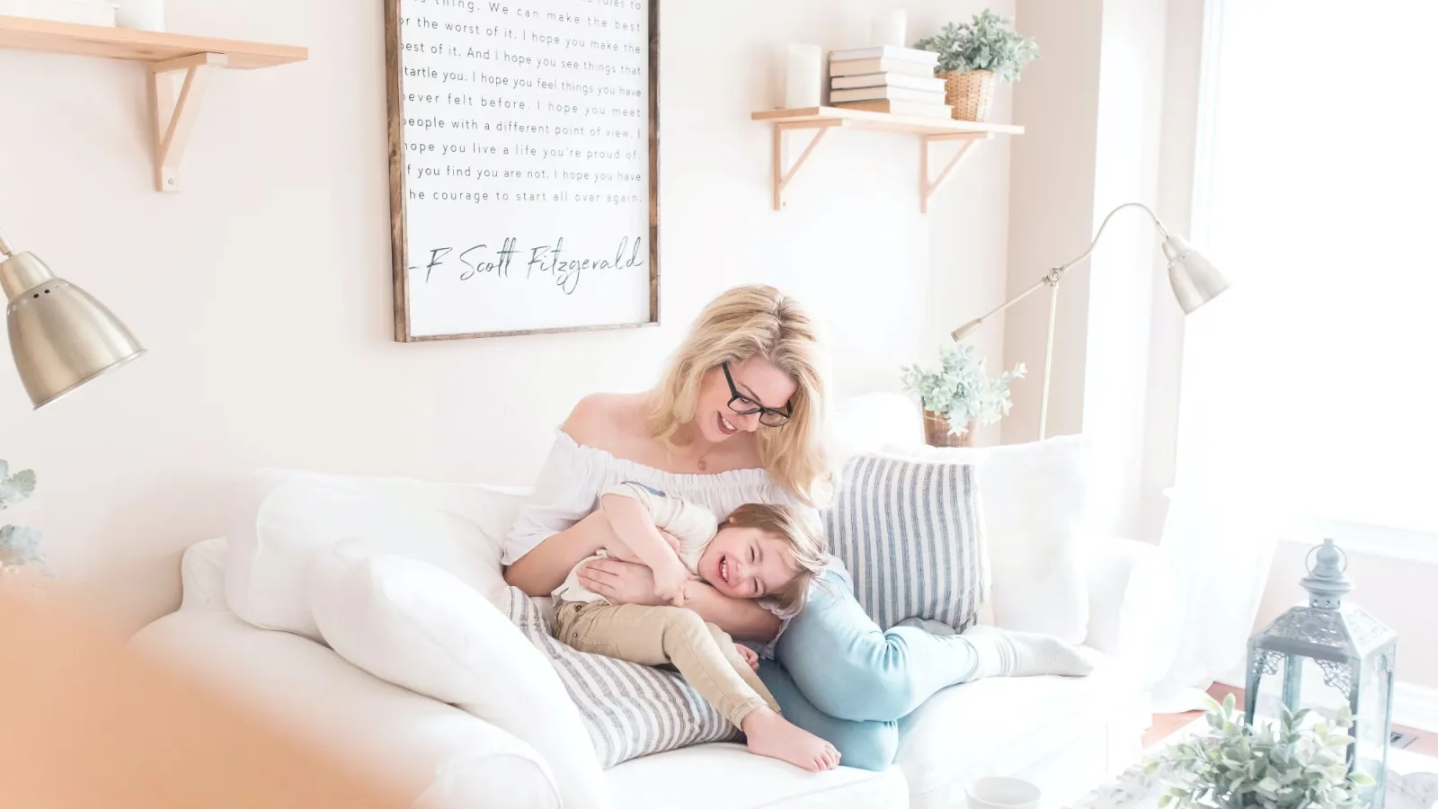 a woman and a baby on a couch