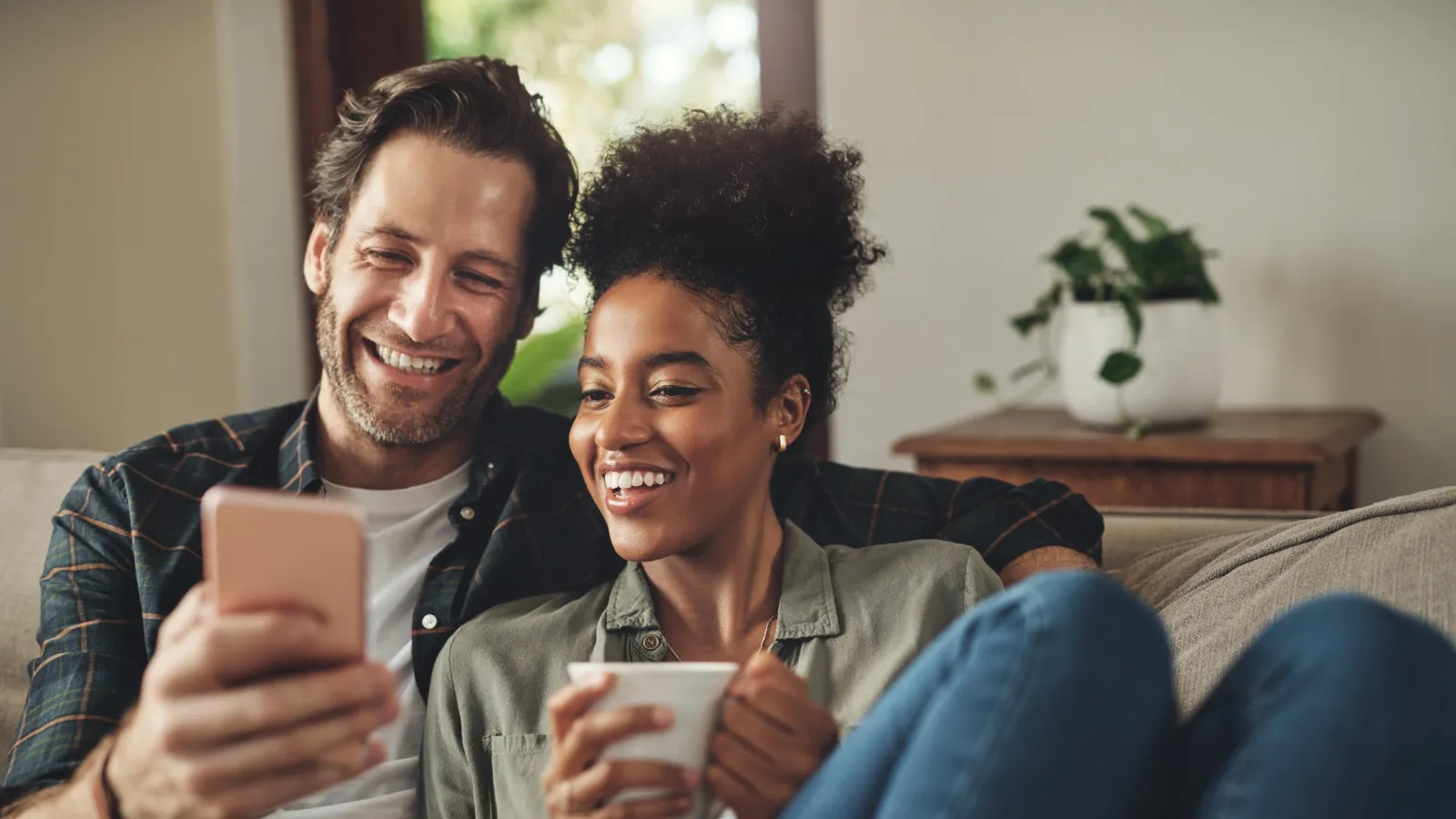 a man and a woman looking at a phone