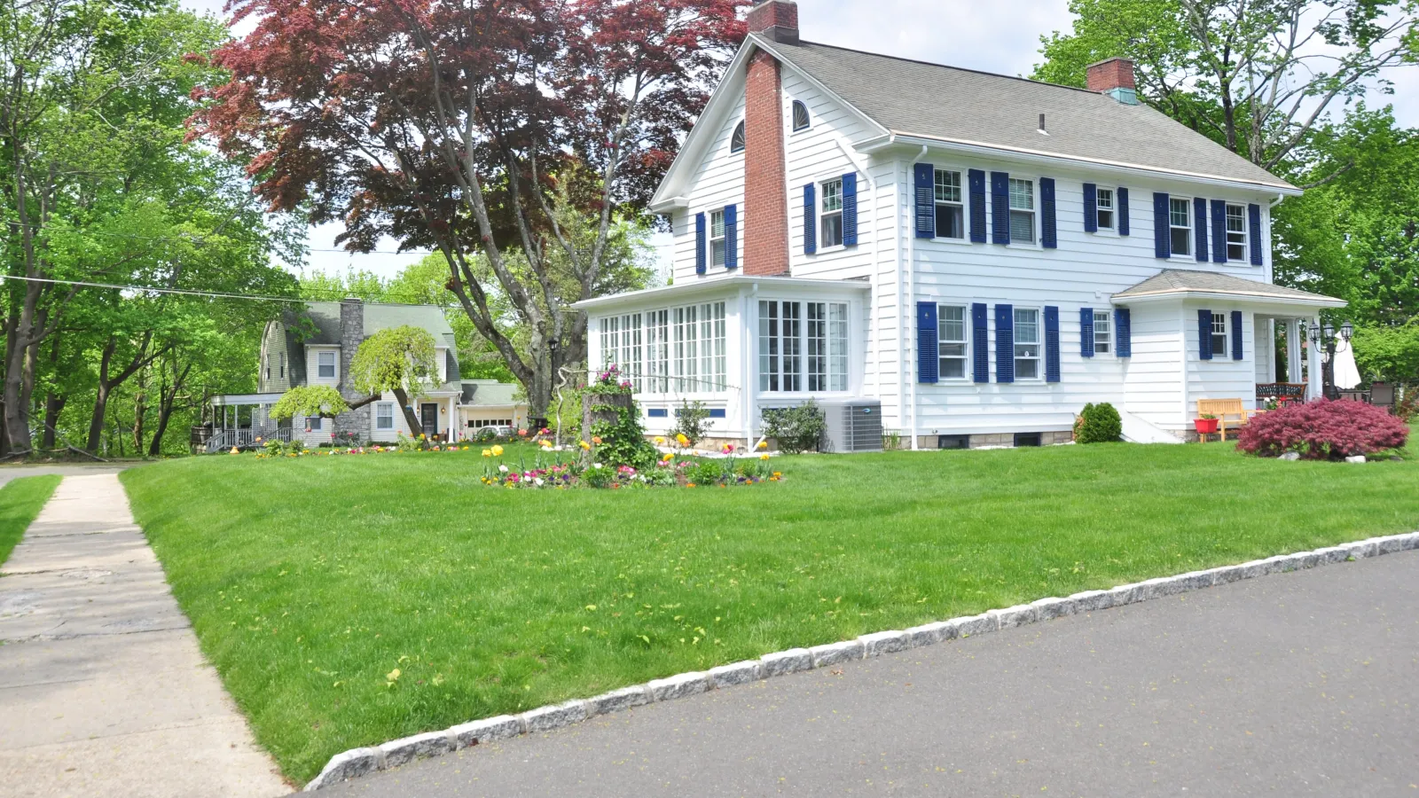 a large white house with a lawn