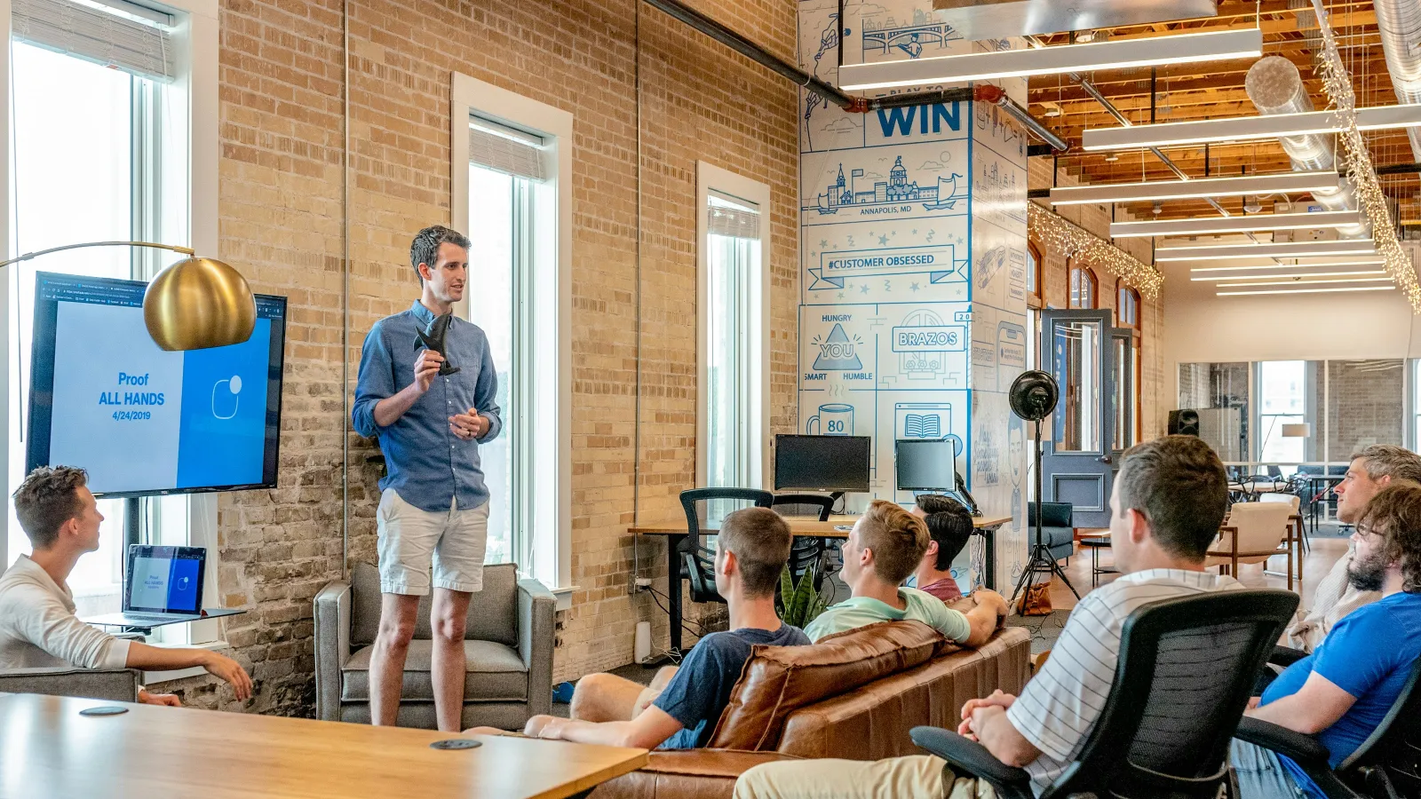 a person speaking to a group of people in a room