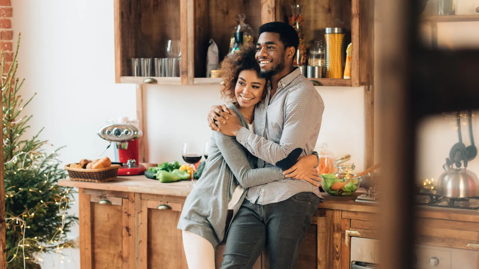 a man and woman hugging in a kitchen