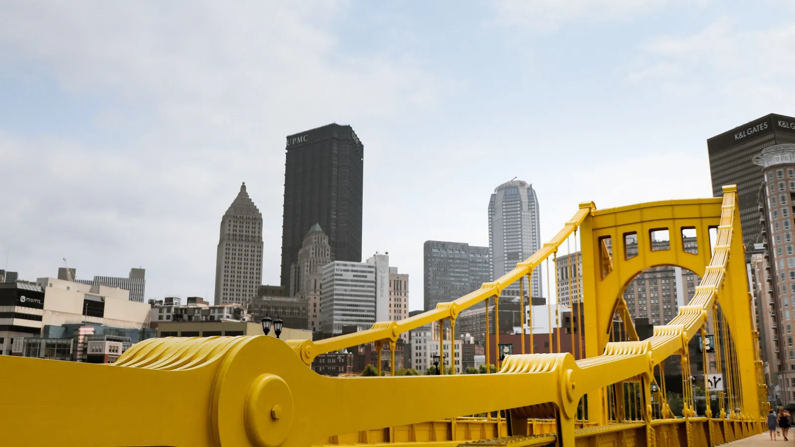 a yellow building with a city in the background