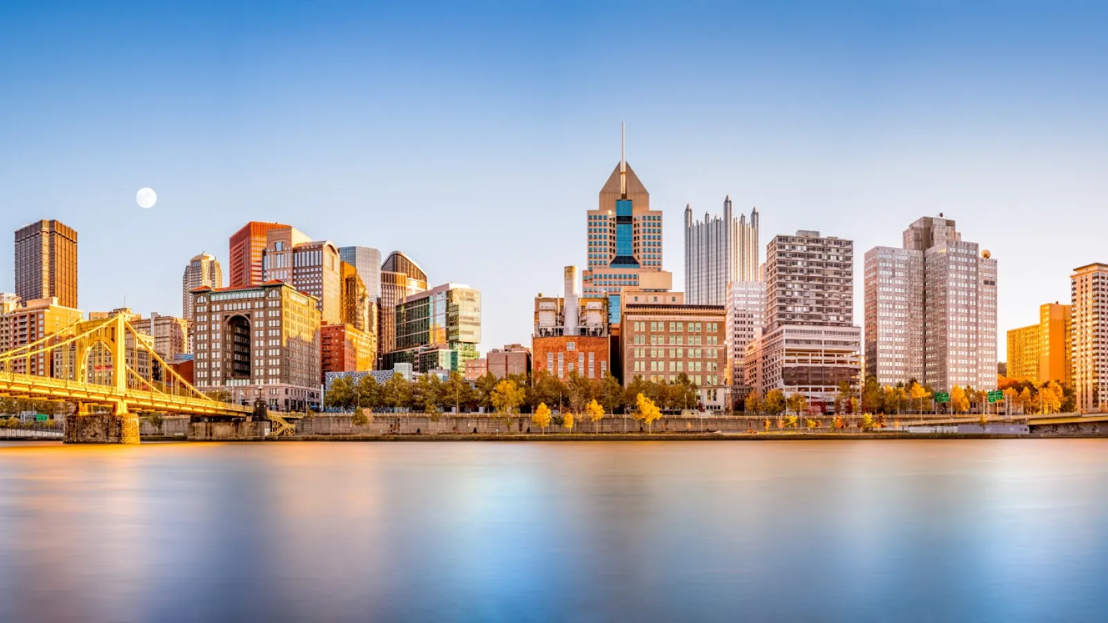 a city skyline with a bridge and water