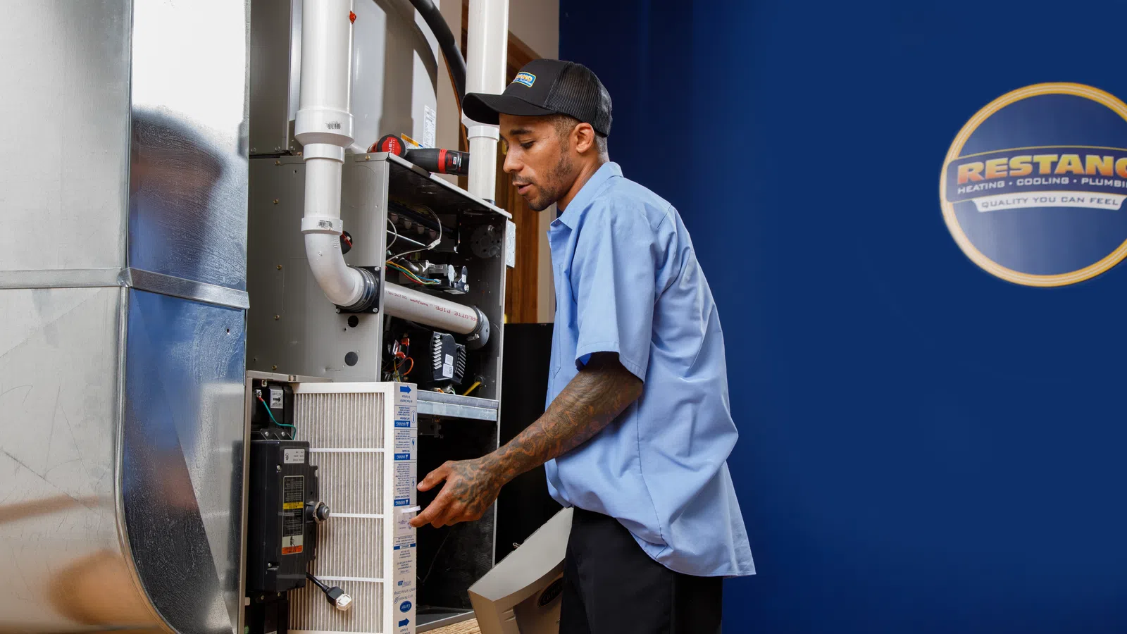 A technician performs maintenance on a heating system in a professional setting.