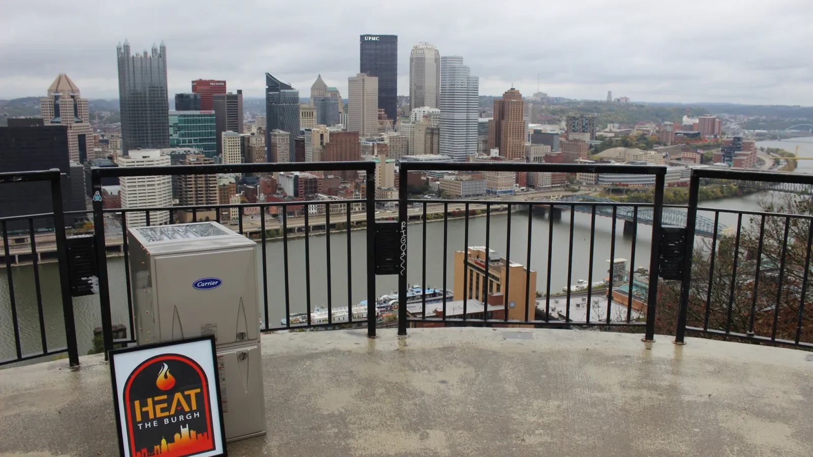 a city skyline with a metal fence