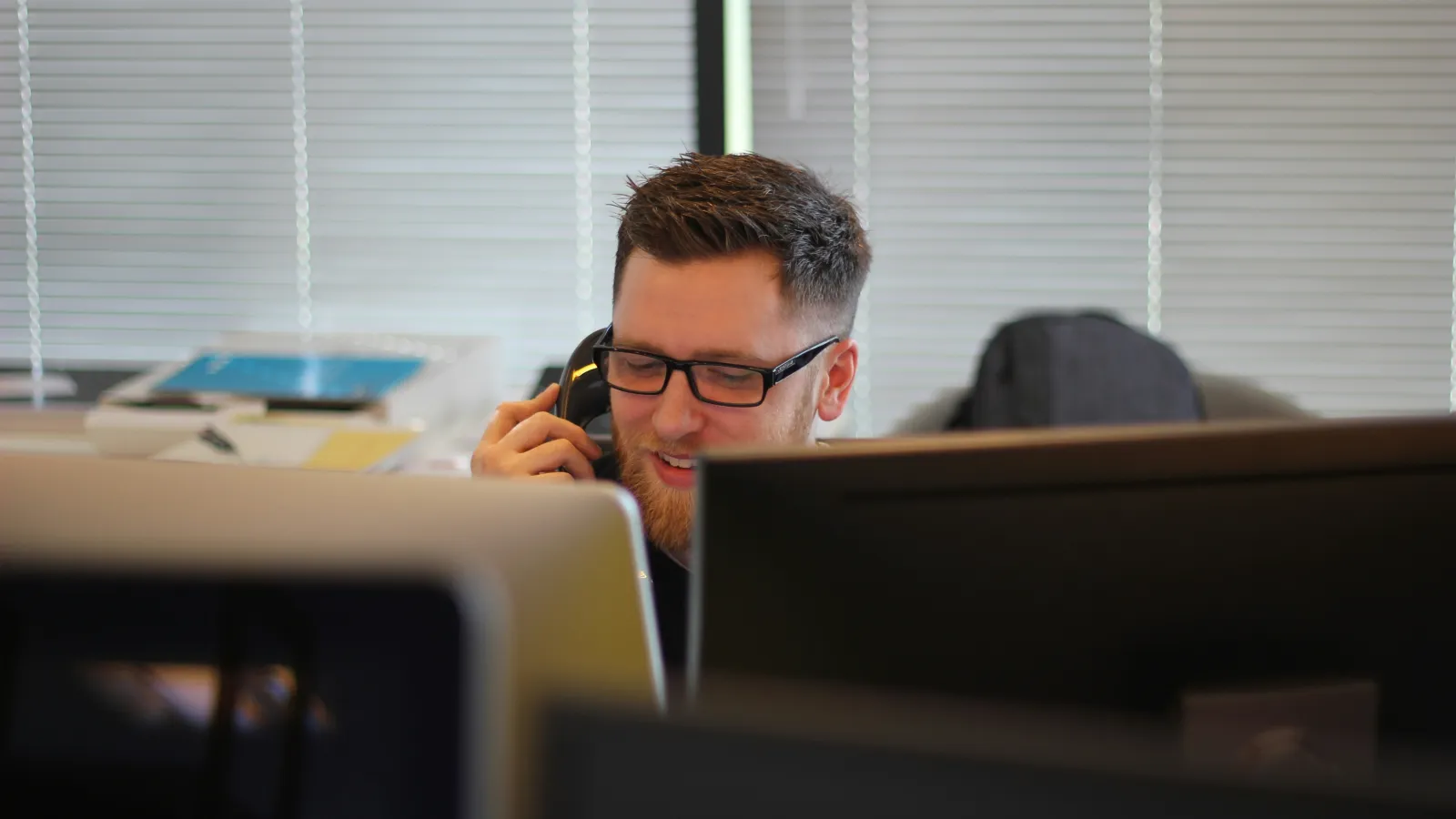 a man on a phone at a desk