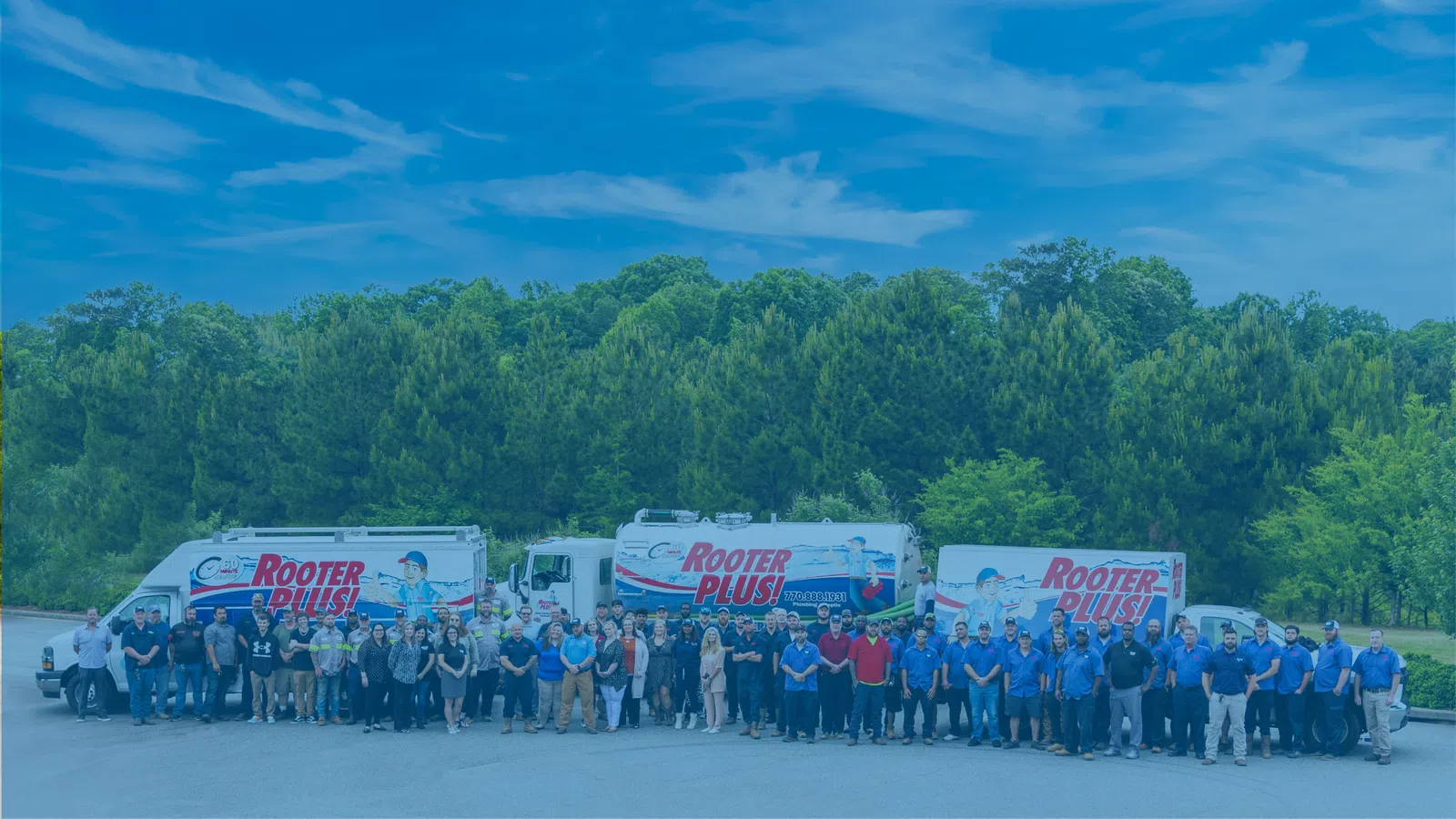 a group of people standing in front of a group of trucks