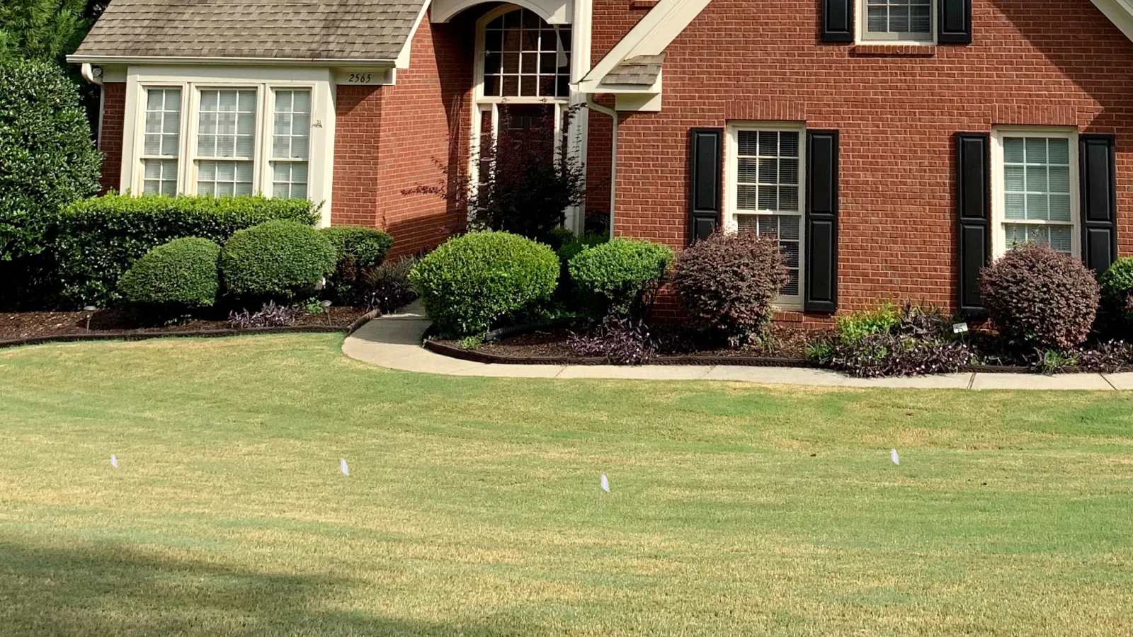 a brick house with a lawn