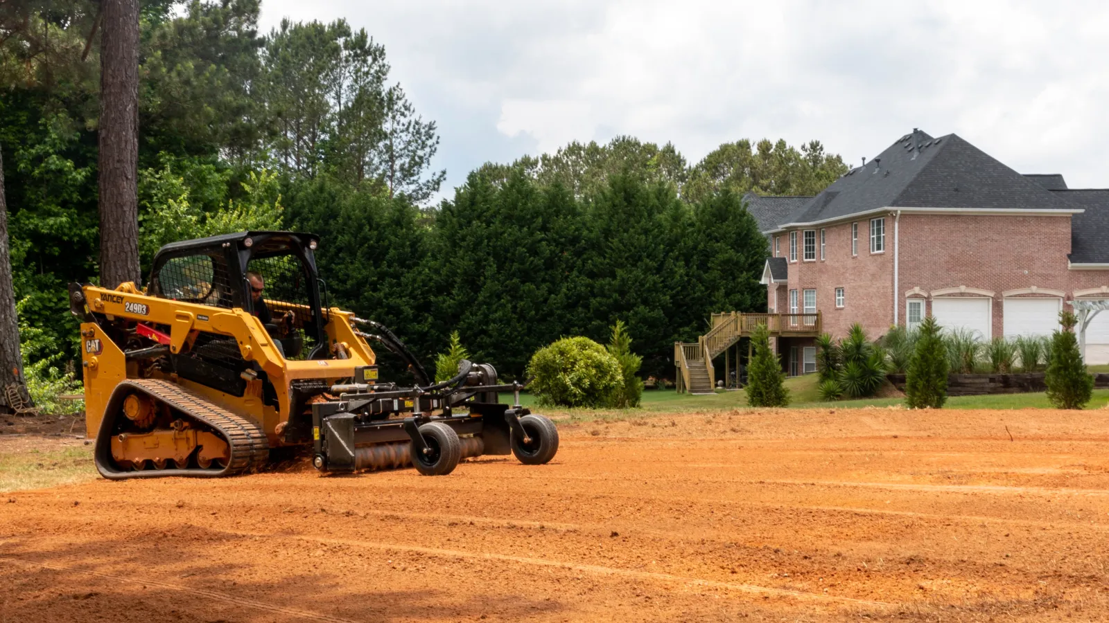 a yellow tractor on a dirt road