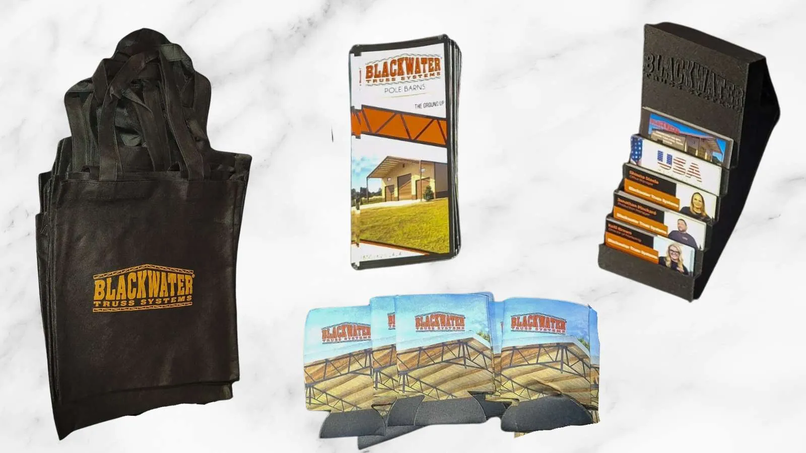 Blackwater Truss Systems branded tote bags, brochures, business cards, and drink koozies on a marble surface.