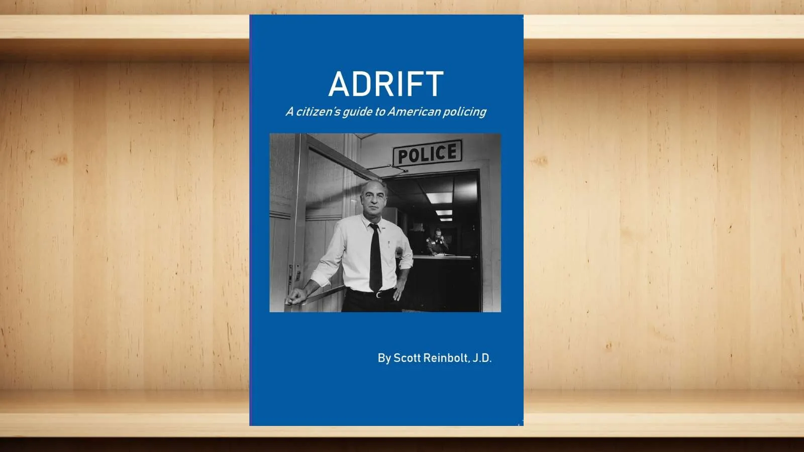 Book cover for Adrift, a citizen's guide to American policing by Scott Reinbolt with a black and white police station photo.