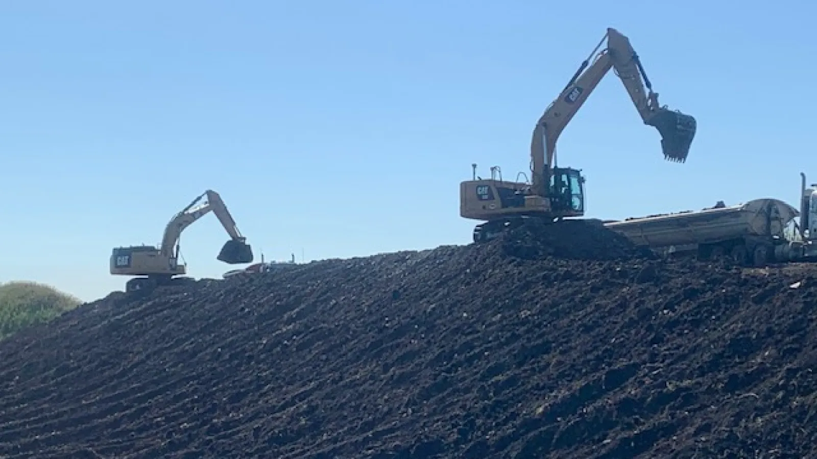 a few machines working on a hill