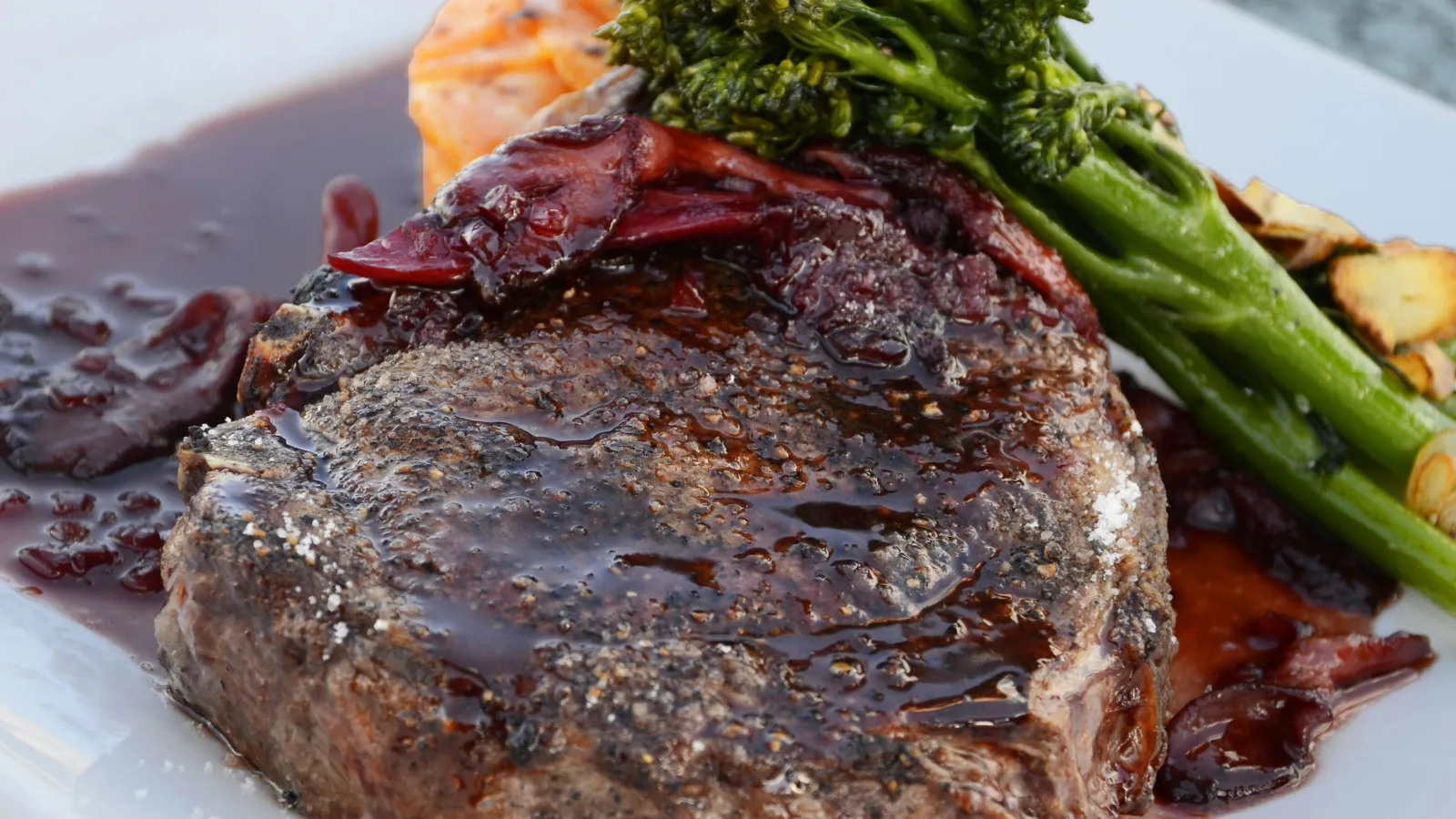 a plate of steak and vegetables