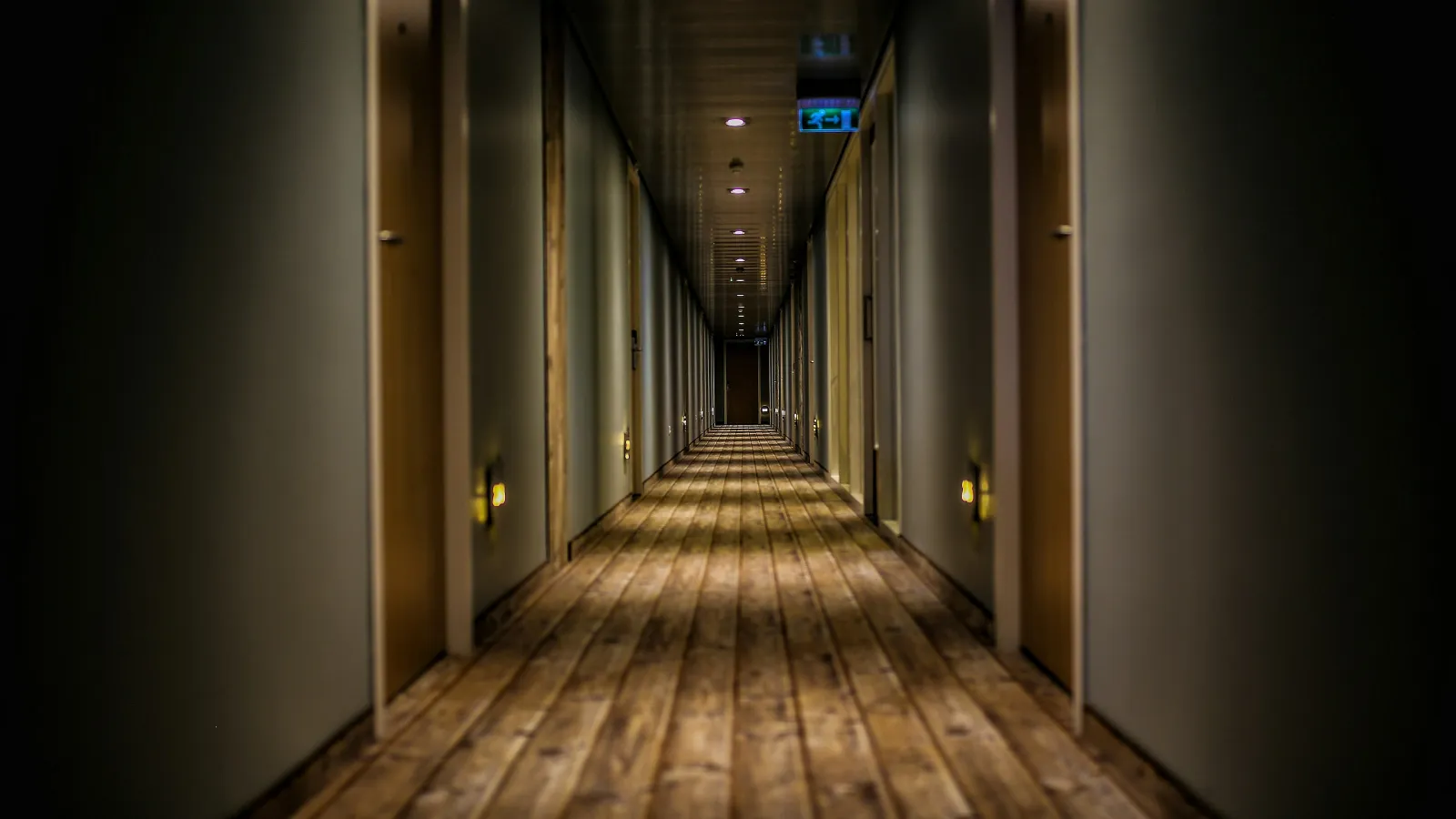 a long hallway with wooden doors