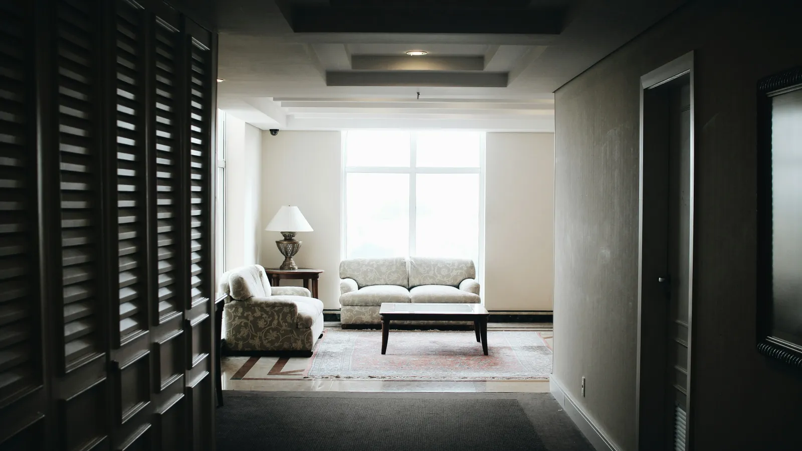 a living room with a couch and a lamp