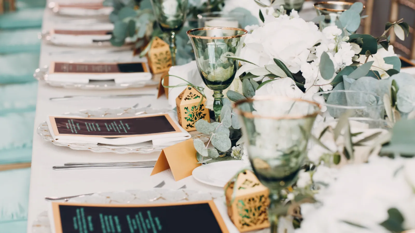 a table with a vase of flowers and a box of tissues