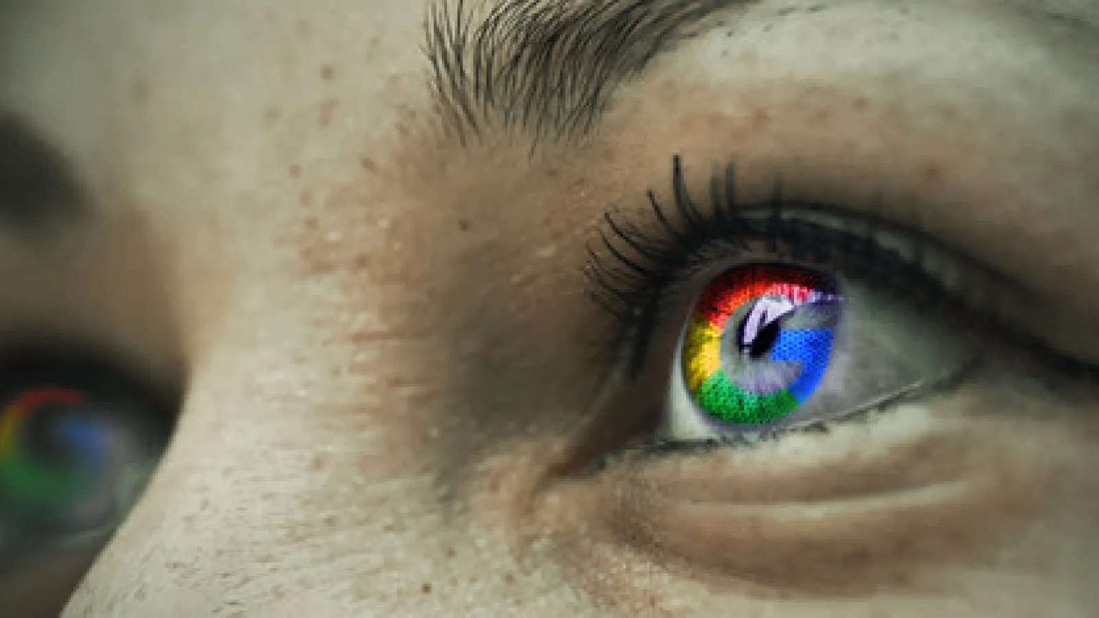 Close-up of a human eye reflecting a colorful digital screen with detailed skin texture and eyelashes.