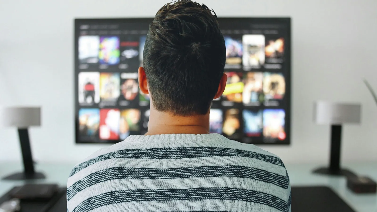 a man looking at a television