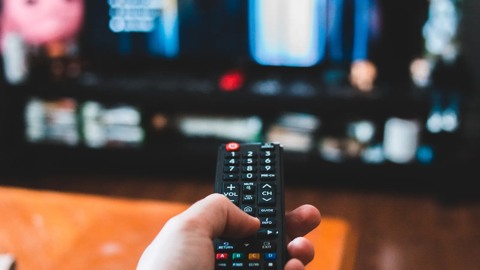 a person holds a remote control