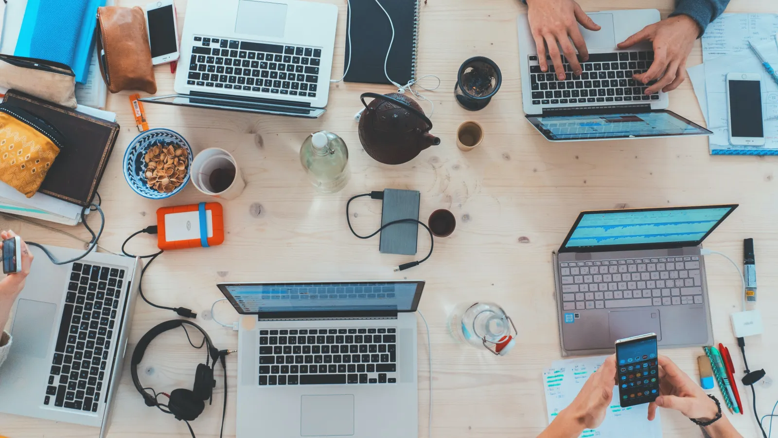 a table with laptops and other electronics on it