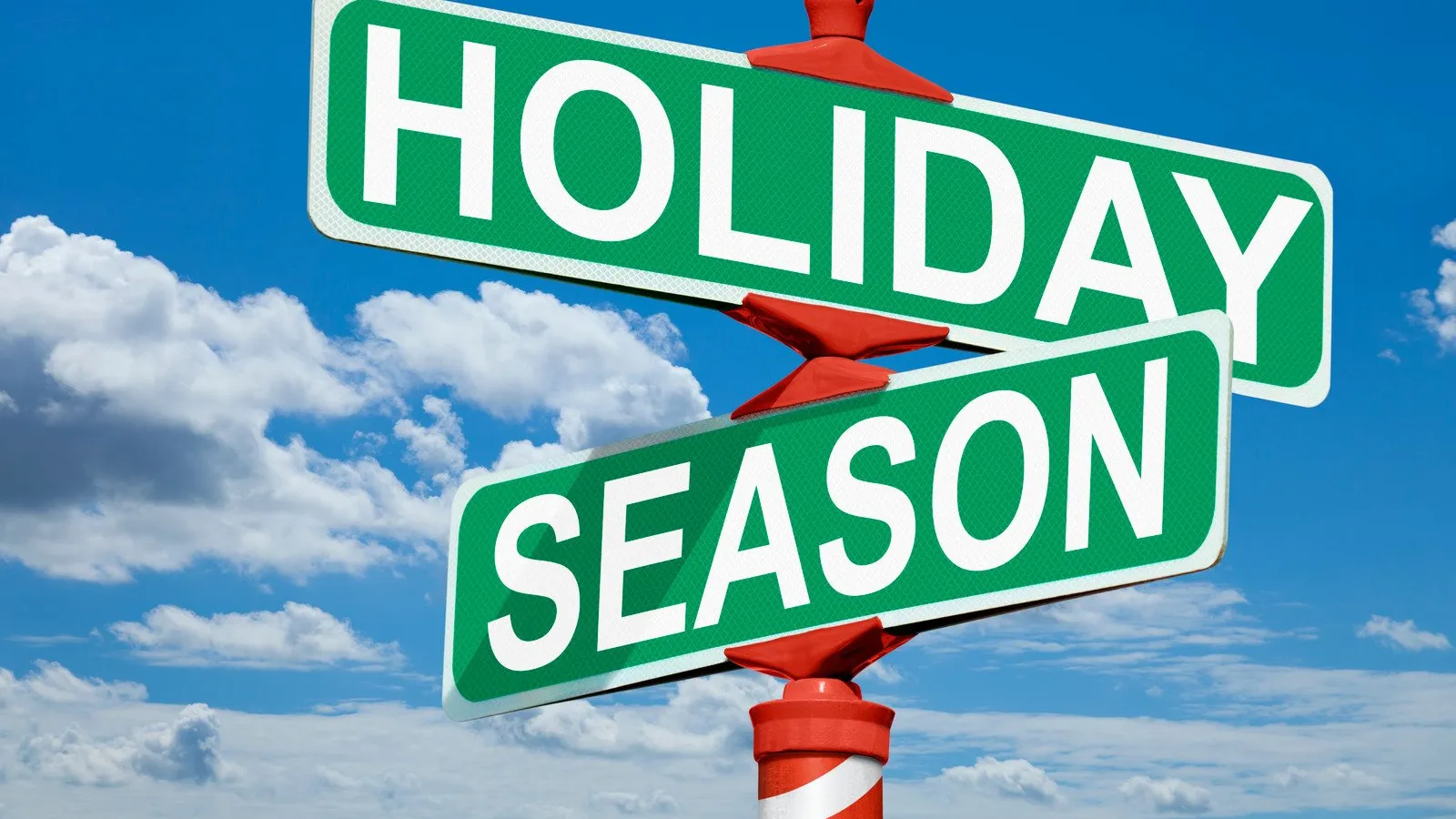 Green street signs reading Holiday and Season against a blue sky with clouds and a candy-cane striped pole.