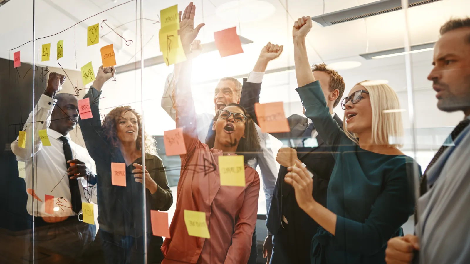 a group of people looking at a book