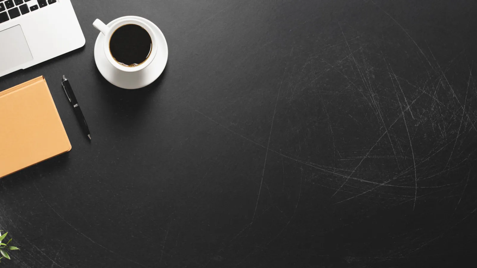 a coffee cup and a notebook on a table
