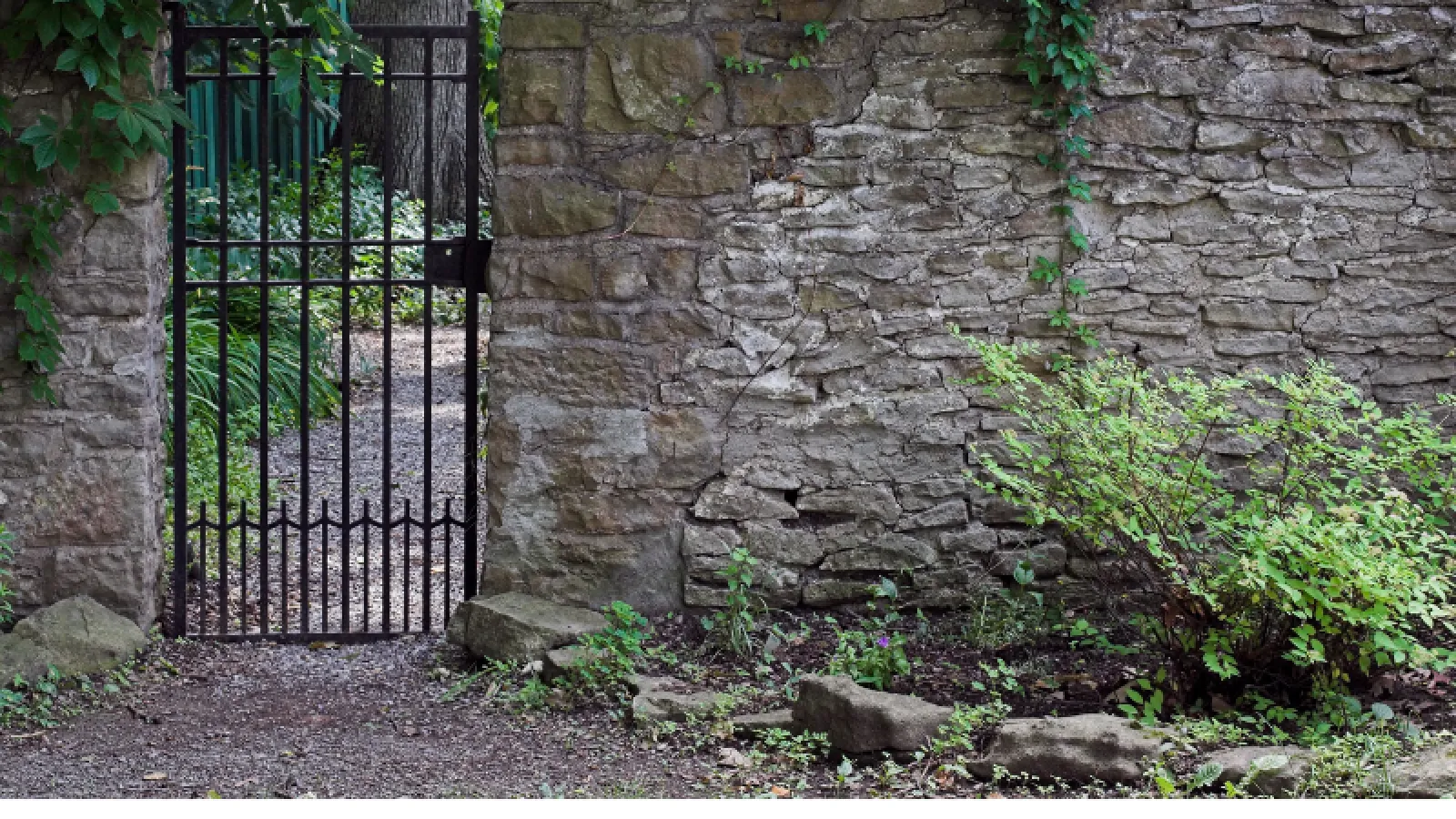 a gate in a stone wall