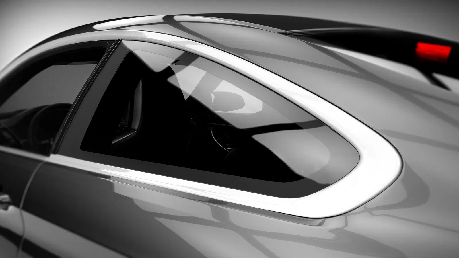 Close-up of a sleek modern car window and chrome trim with glossy silver paint and tinted glass.