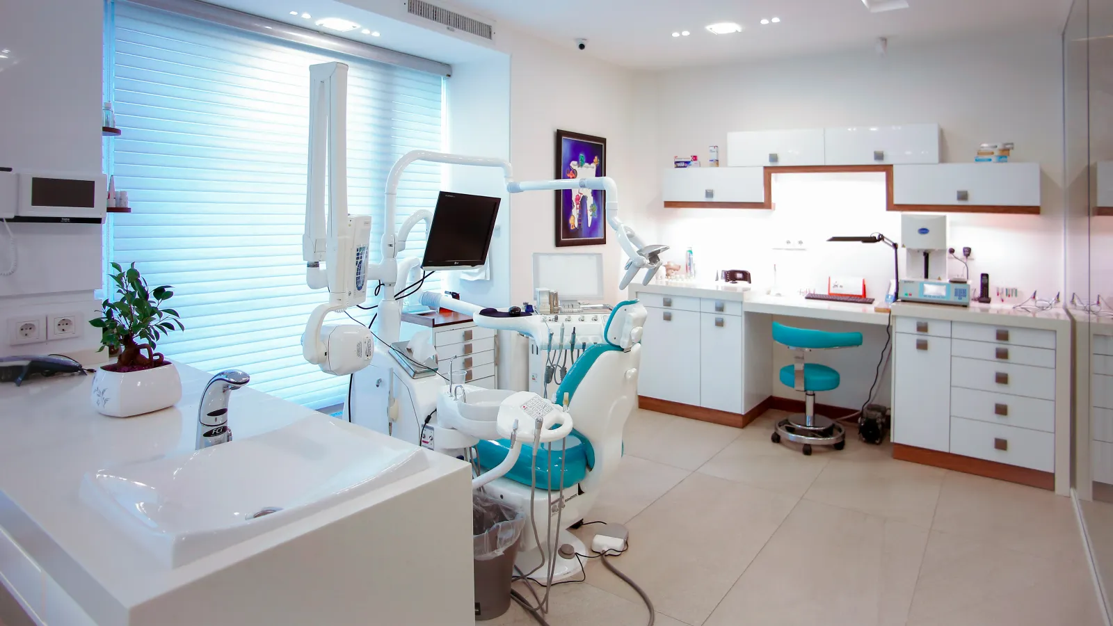 a dental office with a chair and a computer