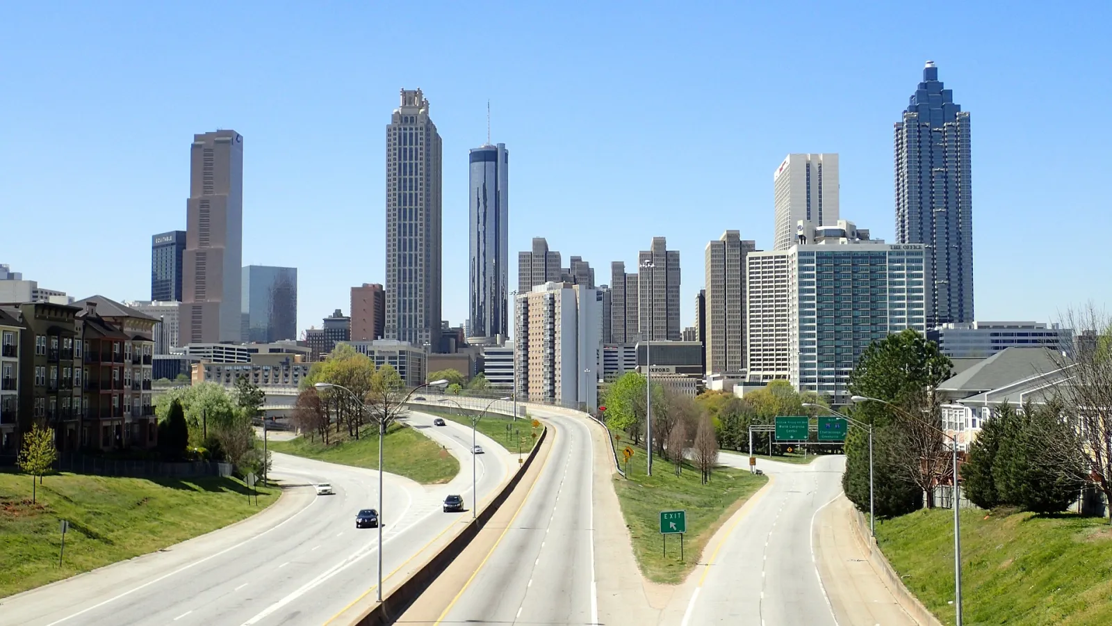 a road with cars and buildings on either side of it