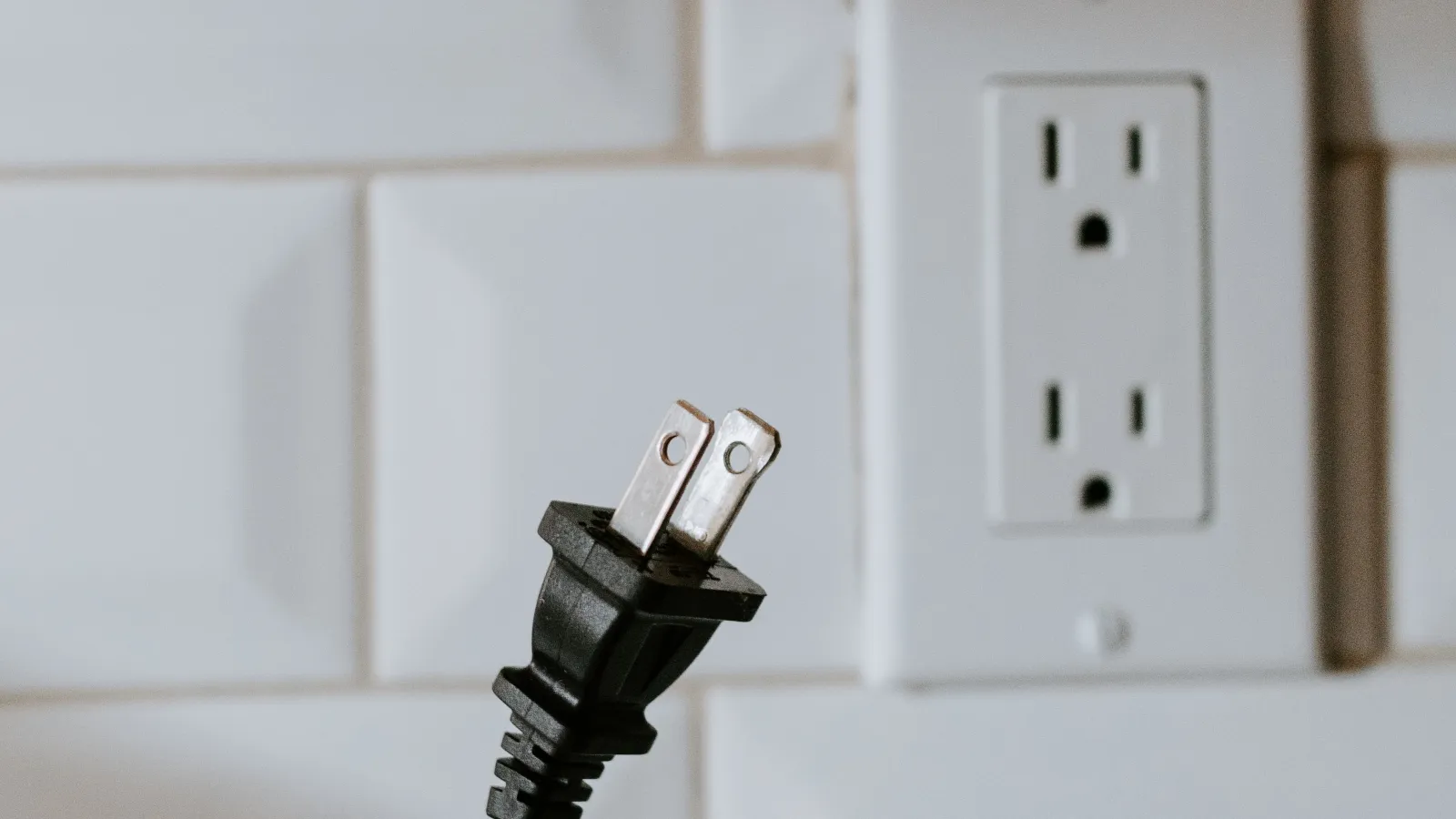 a hand holding a white cord