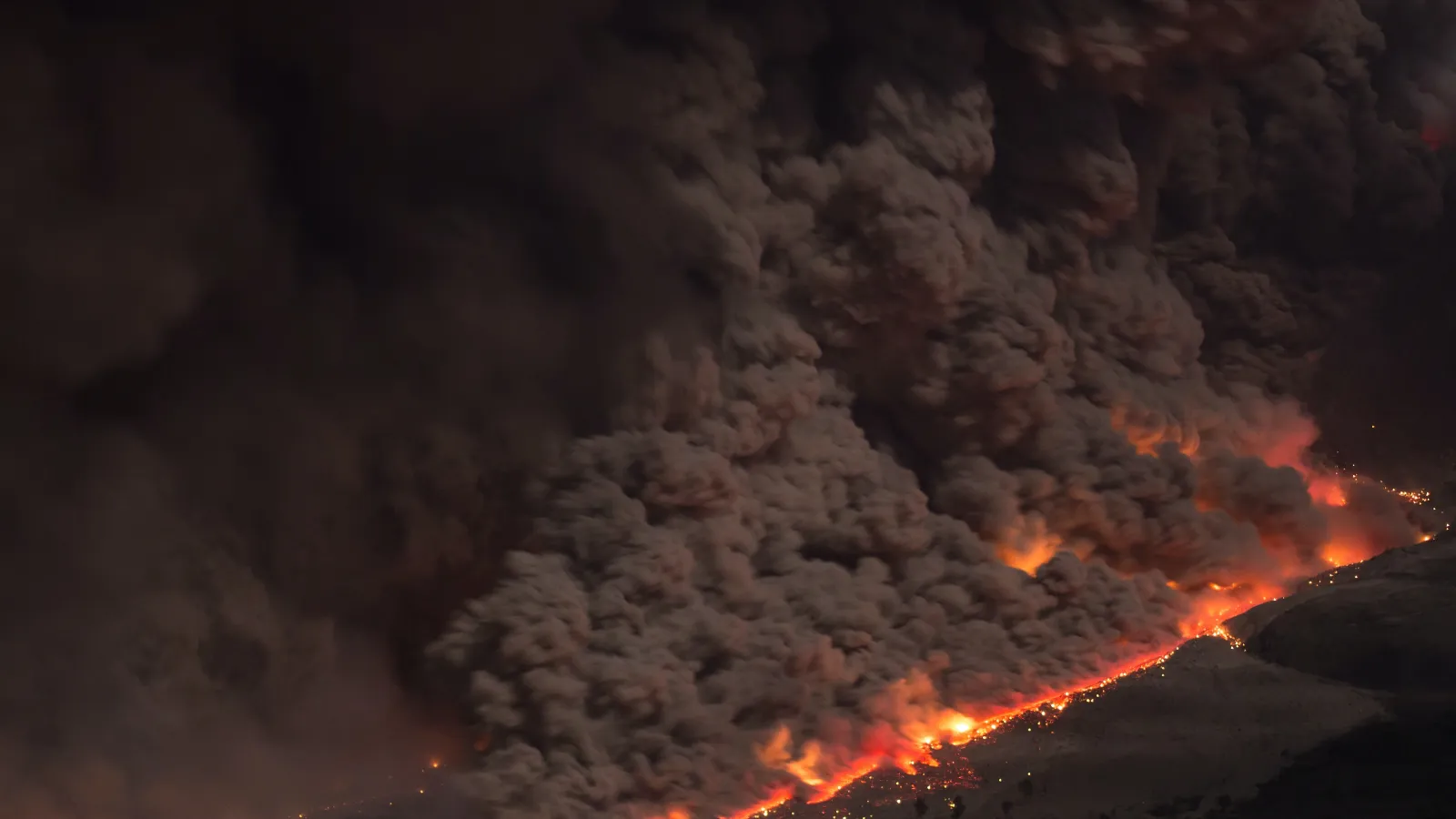 a volcano erupting at night