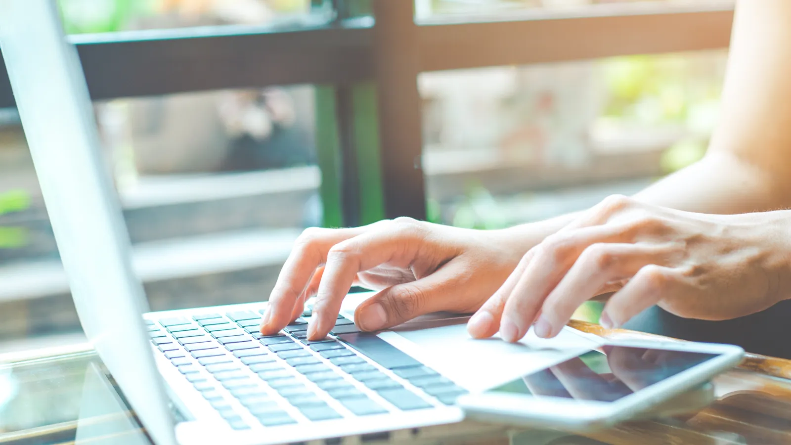 a woman typing on a laptop