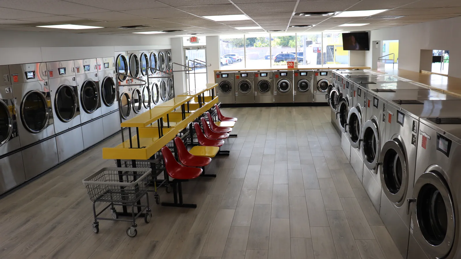 a room with washing machines and chairs