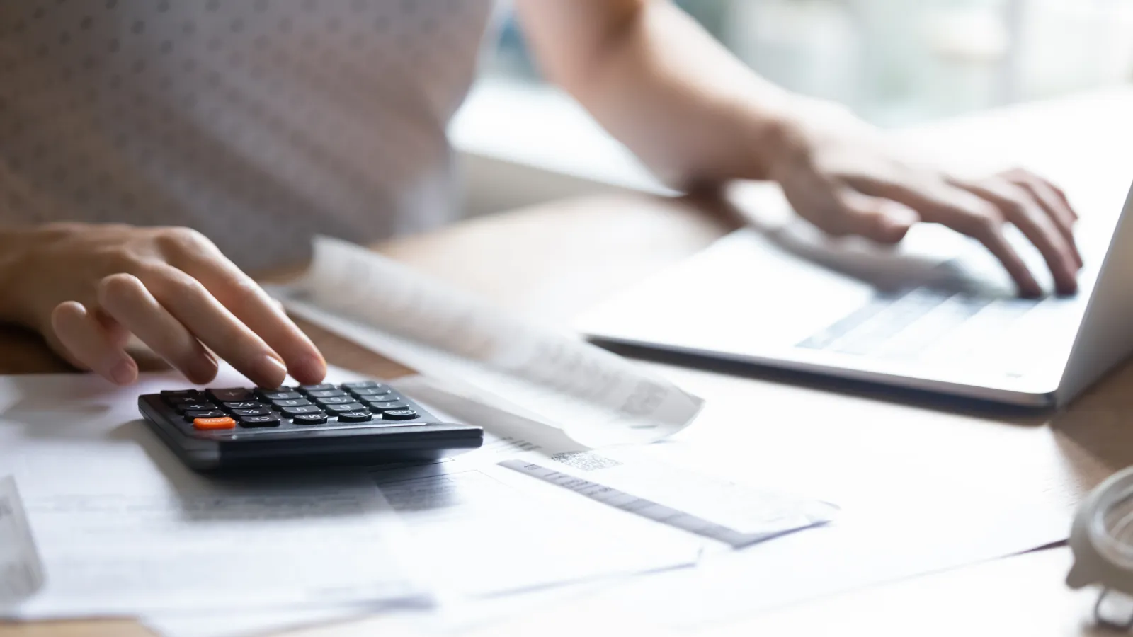 a woman using her calculator while doing bills