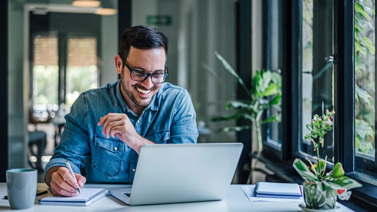 a man sitting at a table with a laptop