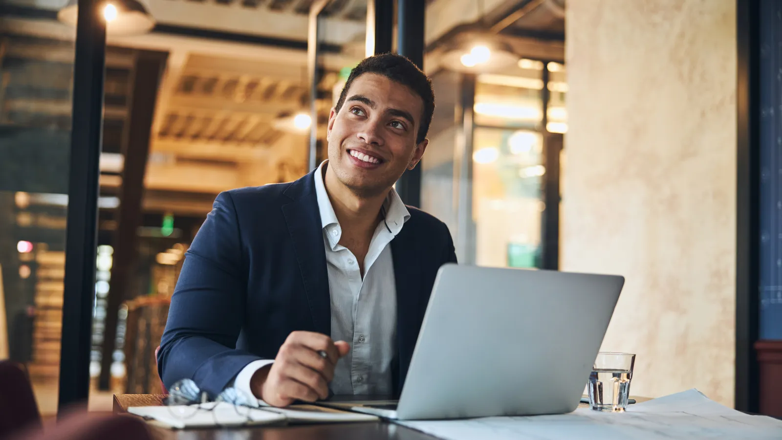 a person sitting at a table with a laptop