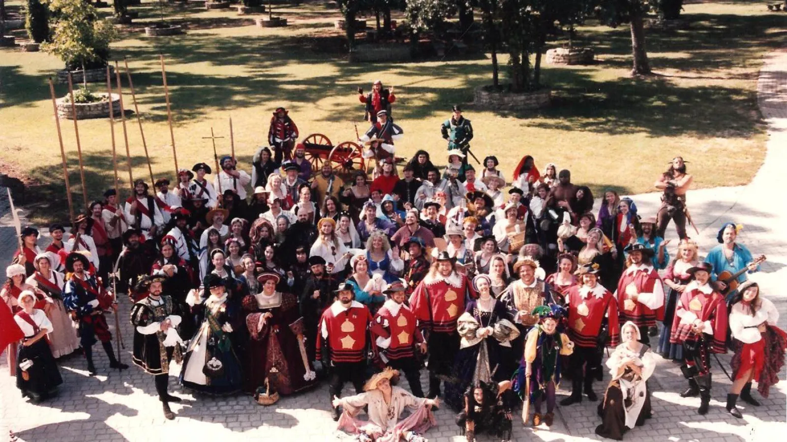 a group of people in front of a crowd posing for the camera