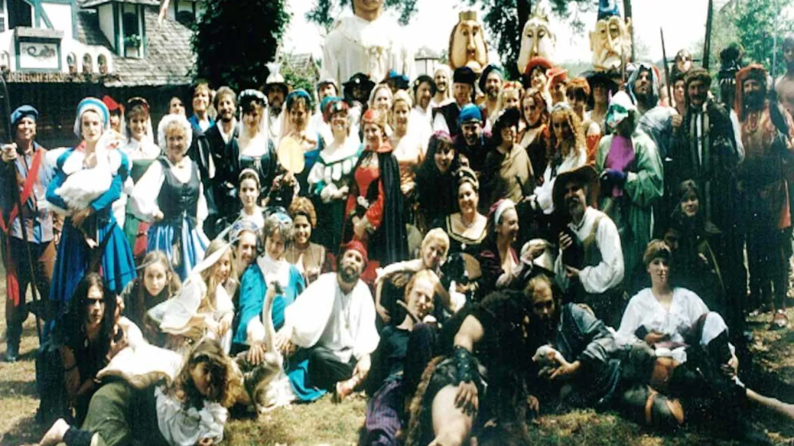 a group of people standing in front of a crowd posing for the camera