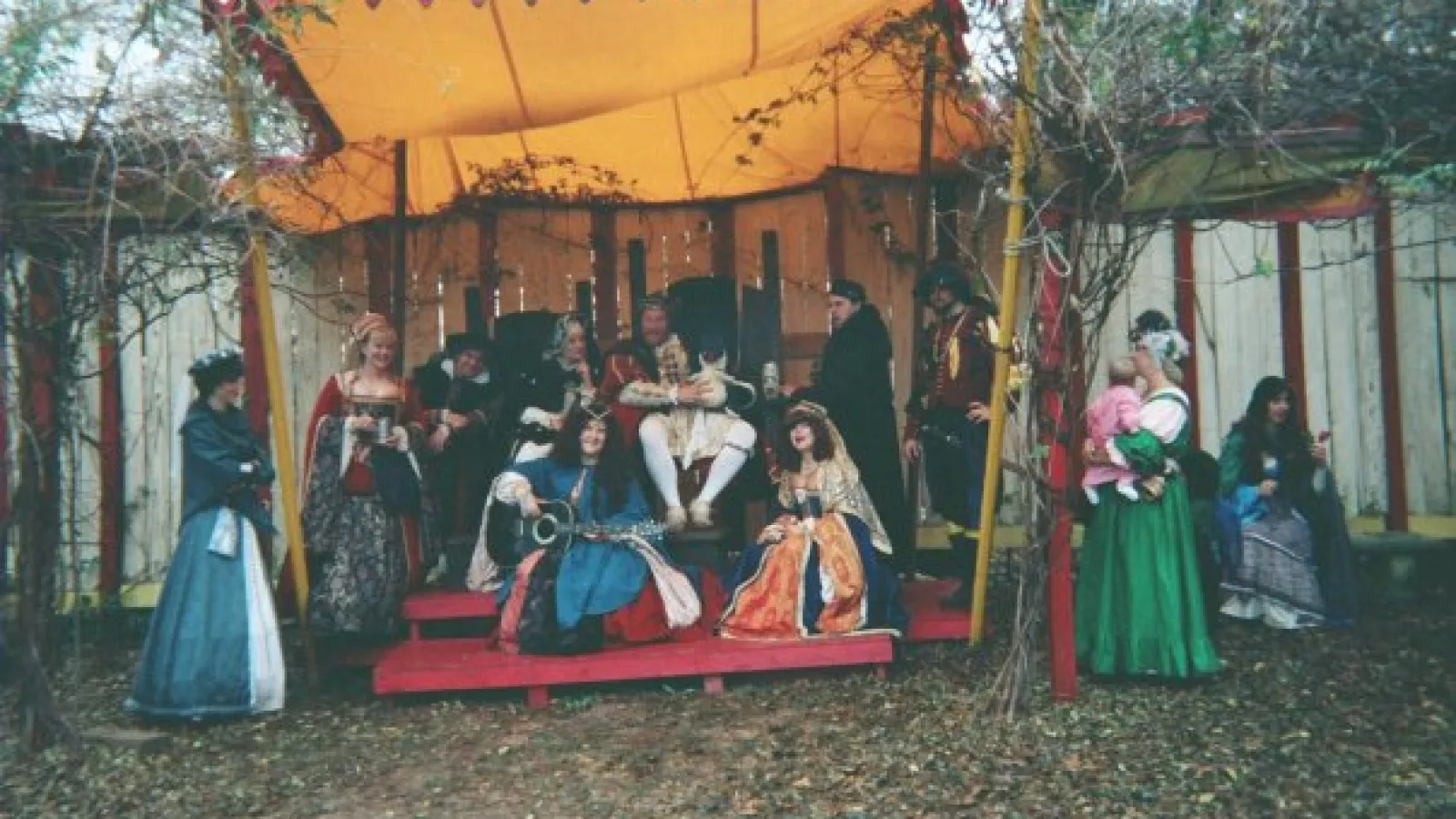 a group of people at a fruit stand