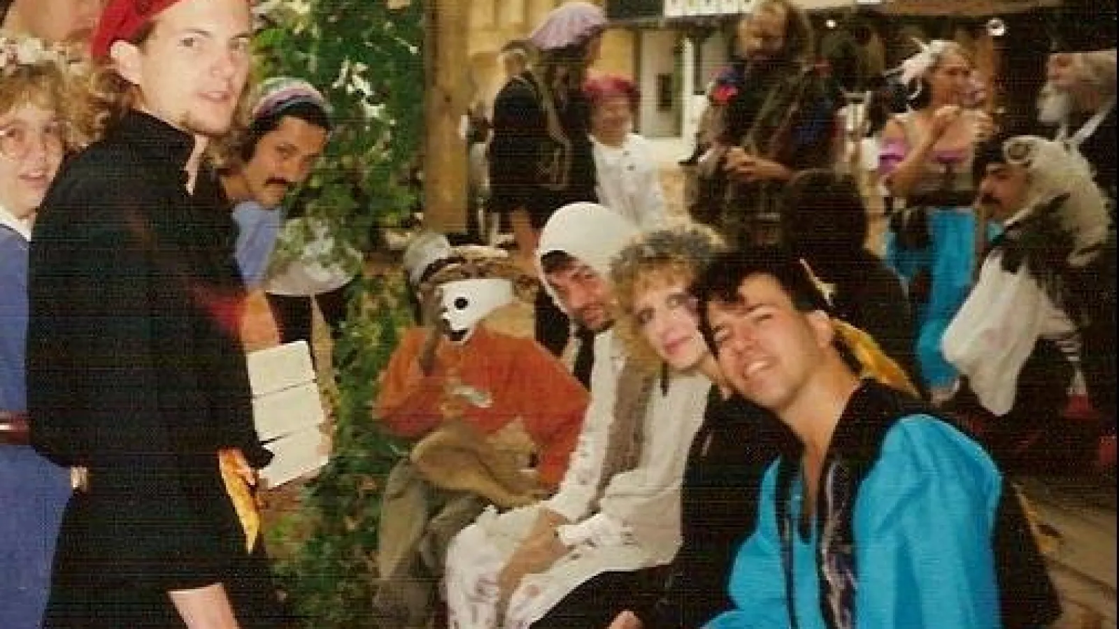 a group of people standing in front of a crowd posing for the camera