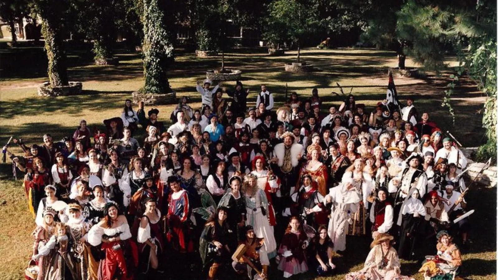 a group of people standing in front of a crowd posing for the camera