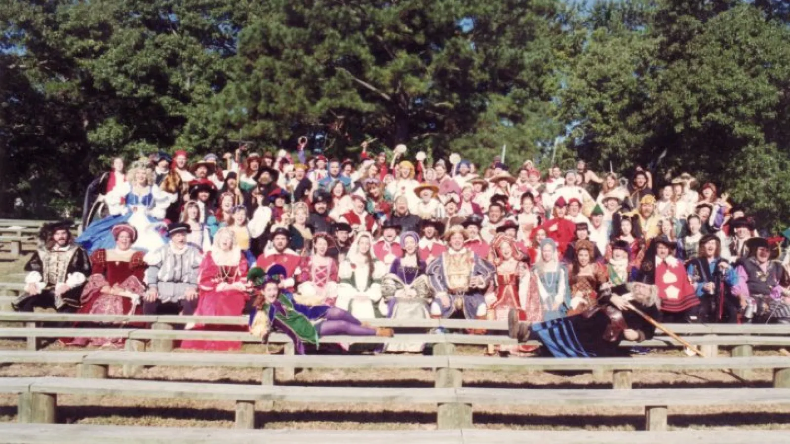 a group of people riding on top of a wooden fence