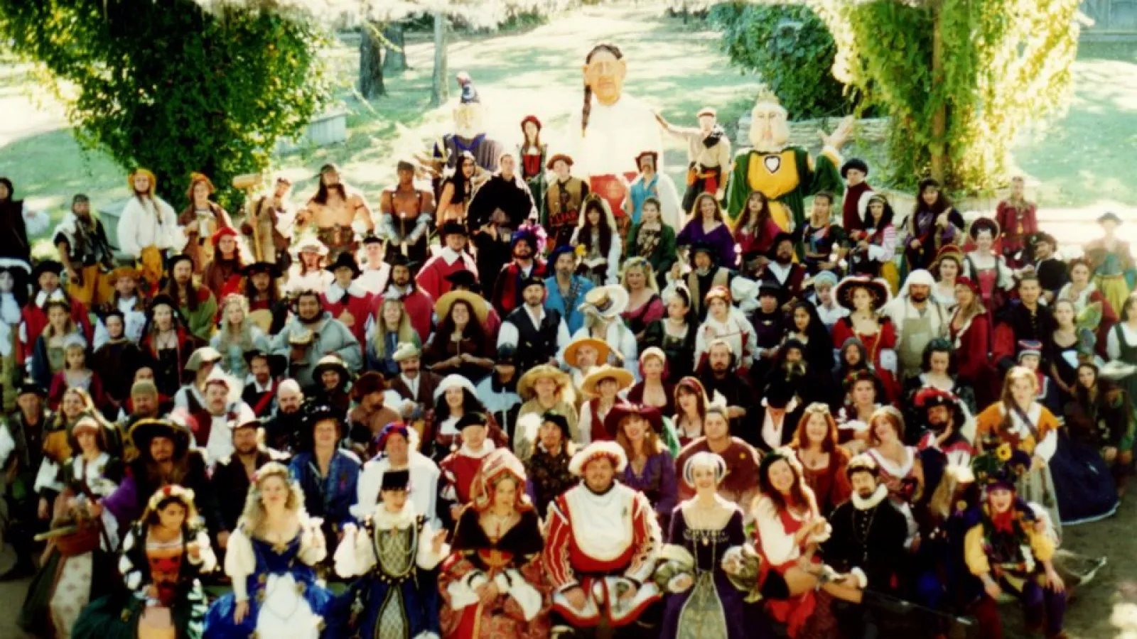 a group of people standing in front of a crowd posing for the camera