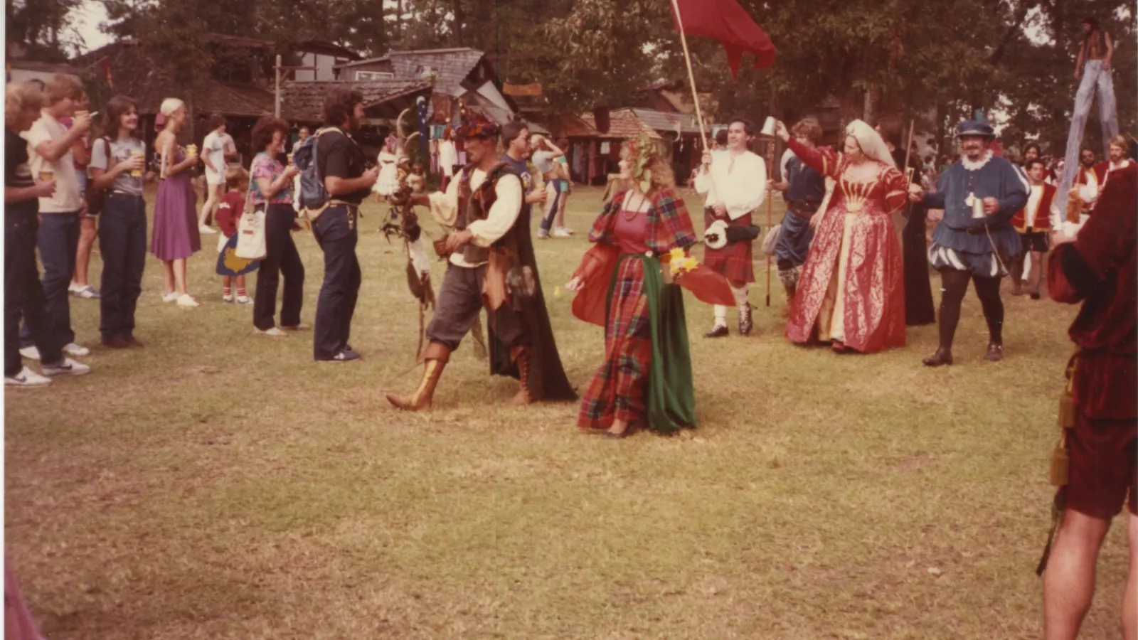 a group of people that are standing in the grass