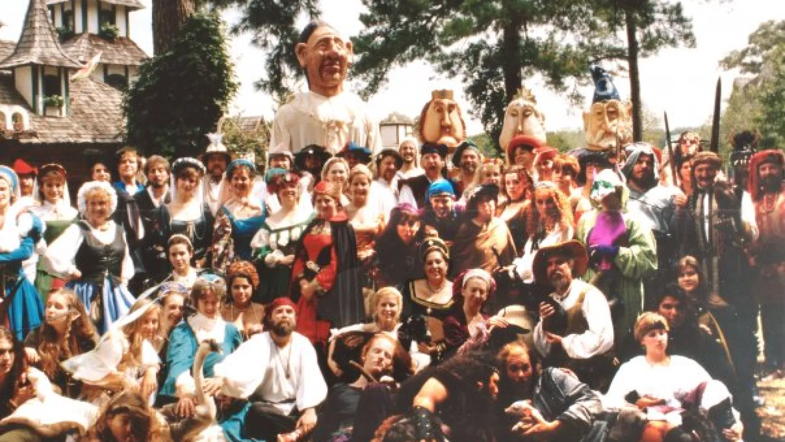 a group of people standing in front of a crowd posing for the camera
